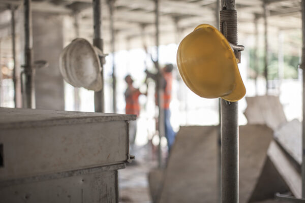 Male builders working on scaffolding on construction site